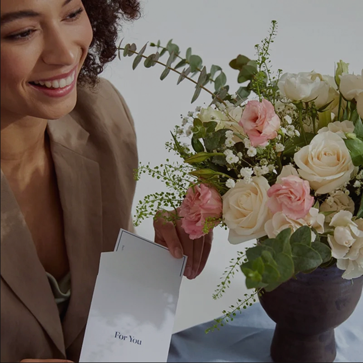 Woman receiving flower subscription delivery